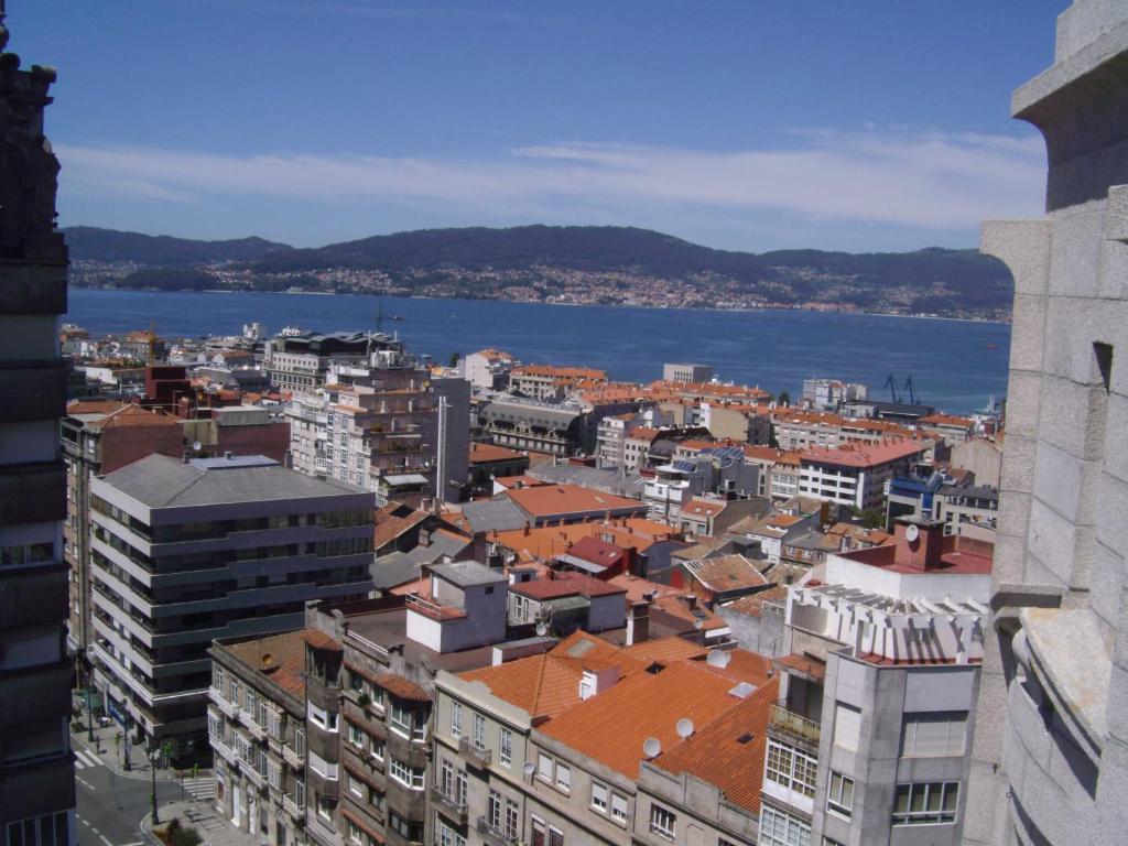 a view of a city with buildings and the water at Zenit Vigo in Vigo