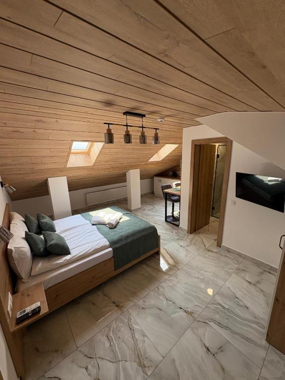 a bedroom with a large bed with a wooden ceiling at *Studio David* in Sibiu