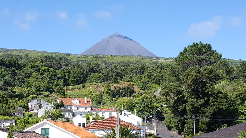 a view of a mountain in the distance with houses at Casavó in São Roque do Pico