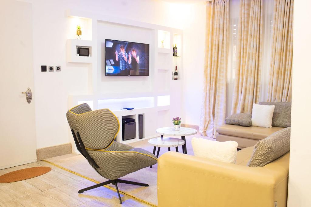 a living room with a couch and a chair at Suit 360 Abuja in Abuja