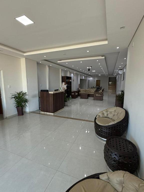 a large lobby with two tires on the floor at AMPARO HOTEL in Ribas do Rio Pardo