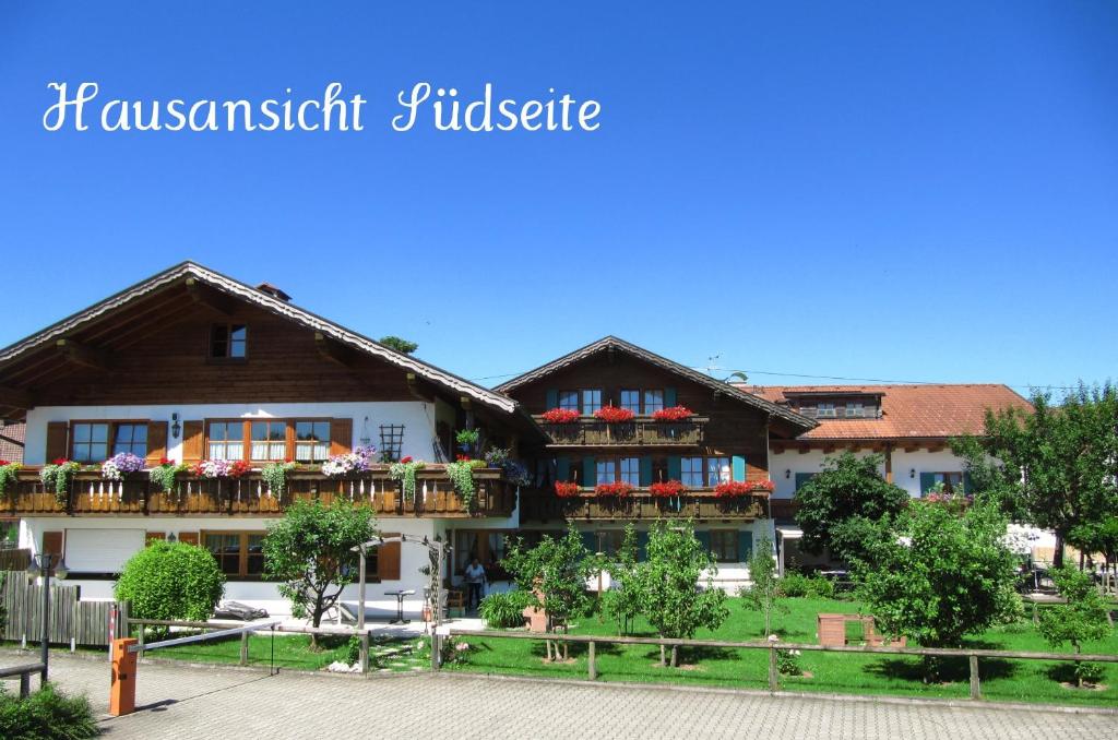 a building with balconies and flowers on it at Gästehaus Seeklause in Schwangau