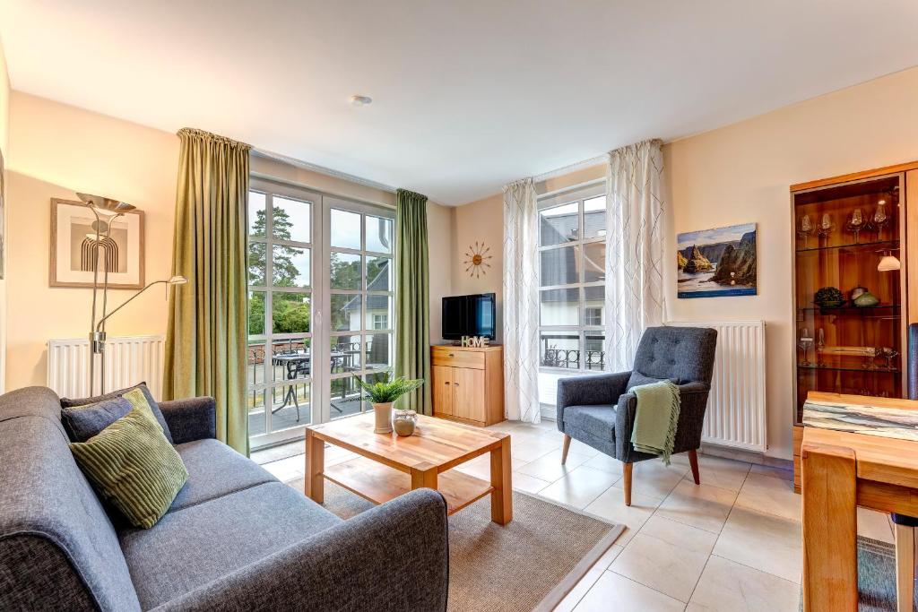 a living room with a couch and two chairs at Residenz am Balmer See - BS 11 mit Wellnessbereich in Balm