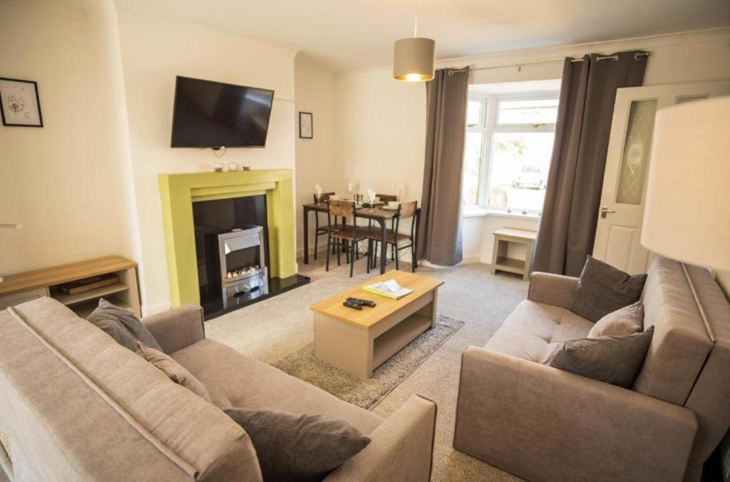 a living room with a couch and a table at Spacious 3 Bedroom Home on South Shields Coast in Westoe