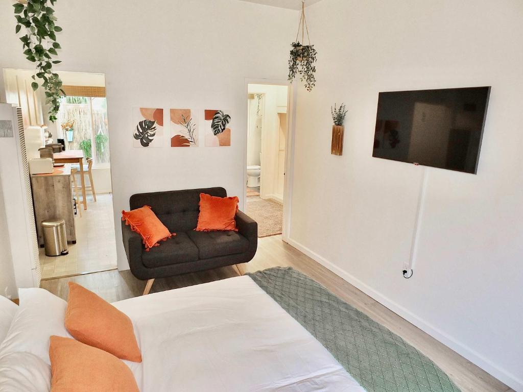 a living room with a couch and a chair at Sand Sun & Second - Charming Studio within Walking Distance to Beach in Long Beach