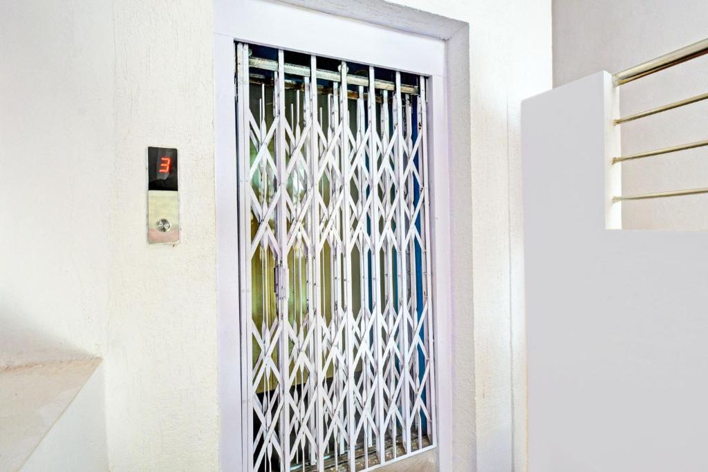 a door with a white fence on it at Hotel O JK Lodge in Hyderabad