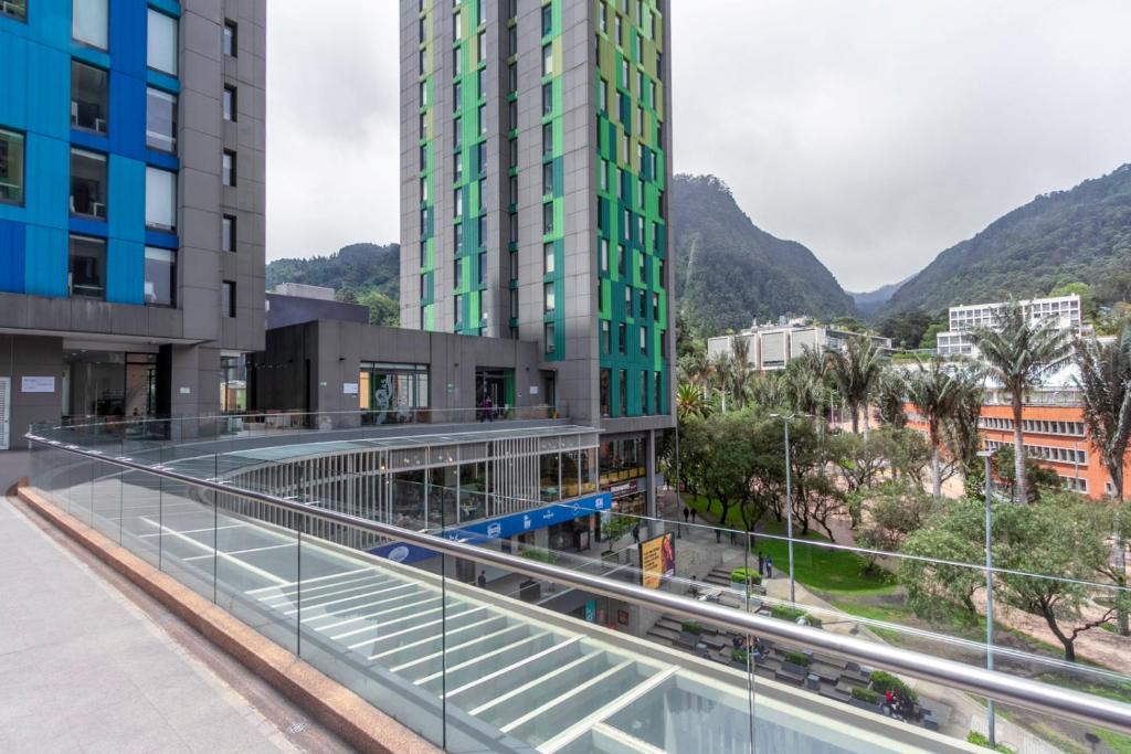 a walkway between two buildings with mountains in the background at Cozy and centrally located flat near Monserrate - 11009 in Bogotá