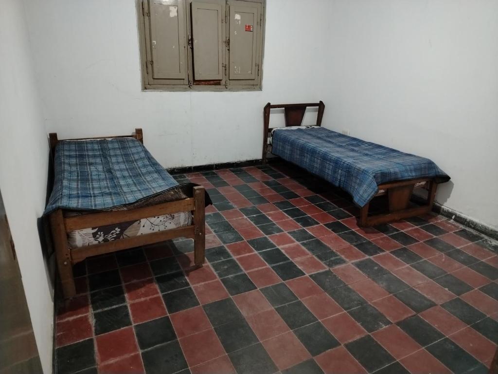 two beds sitting on a tiled floor in a room at Departamento 2 dormitorios in Santiago del Estero
