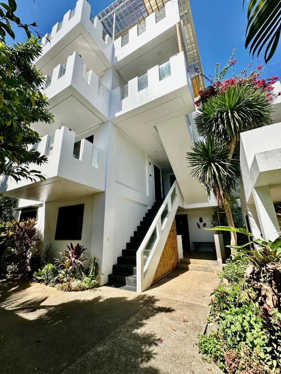 a white house with stairs and plants at Kawayan Terrace - Boracay in Boracay