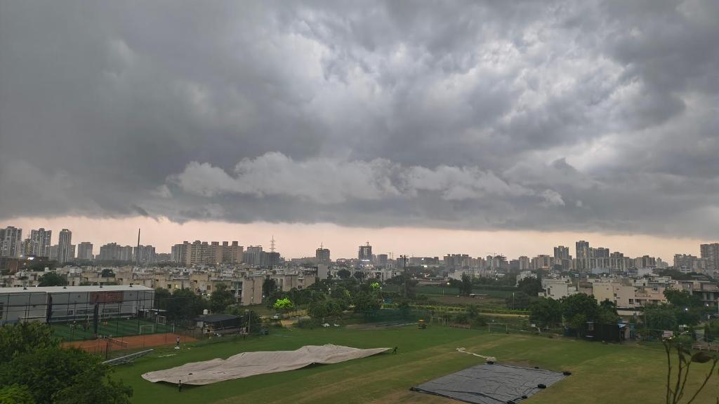 a view of a city under a cloudy sky at Signature Gurgaon House 89 in Gurgaon