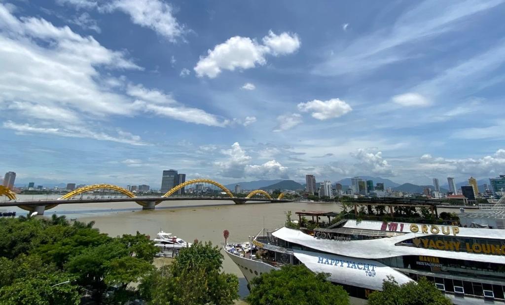 two boats on a river with a bridge in the background at Han Riverside in Da Nang
