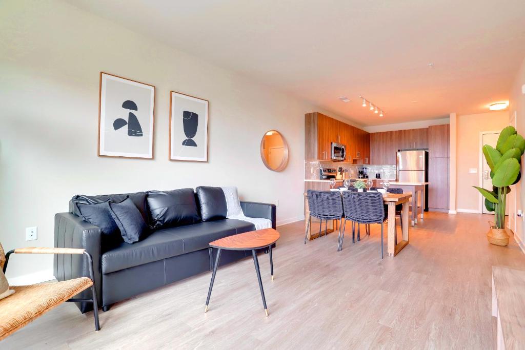 a living room with a couch and a dining room at Exquisite One-Bedroom Apartment in Alexandria in Alexandria