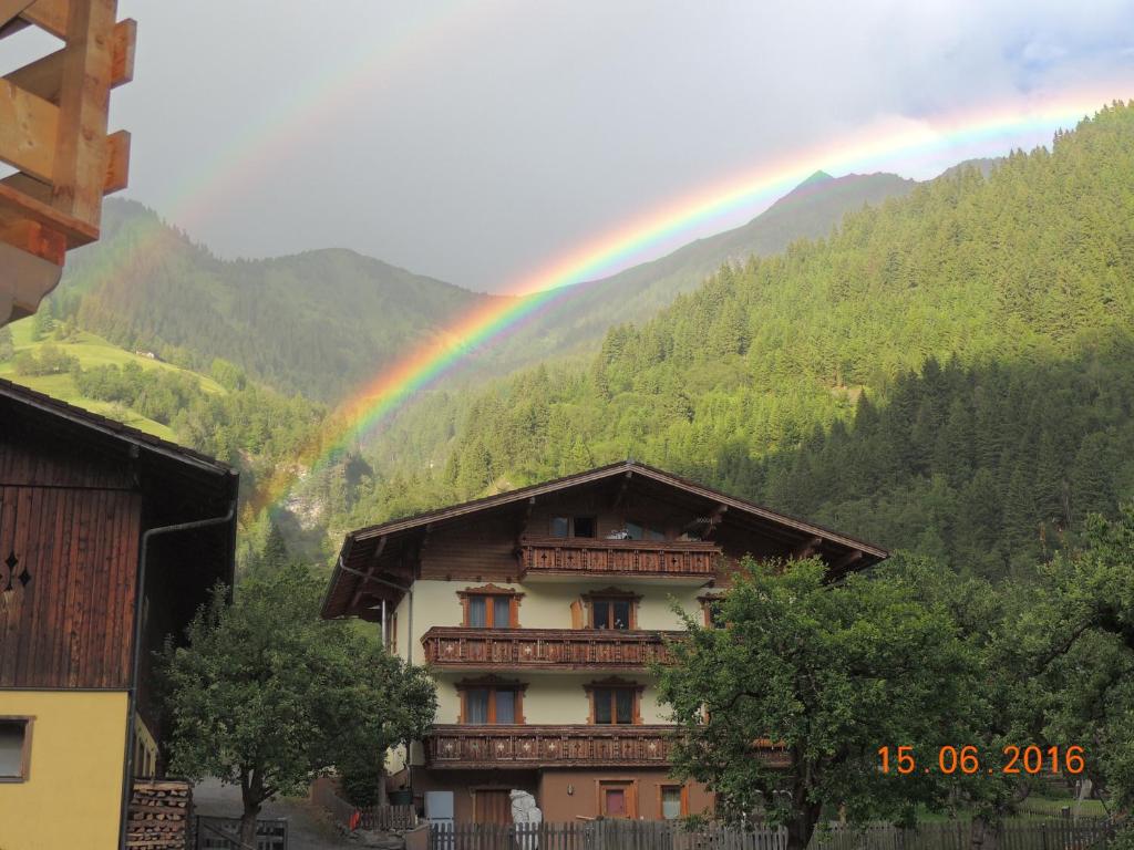 a rainbow over a building with at Hoislbauerngut in Bad Hofgastein