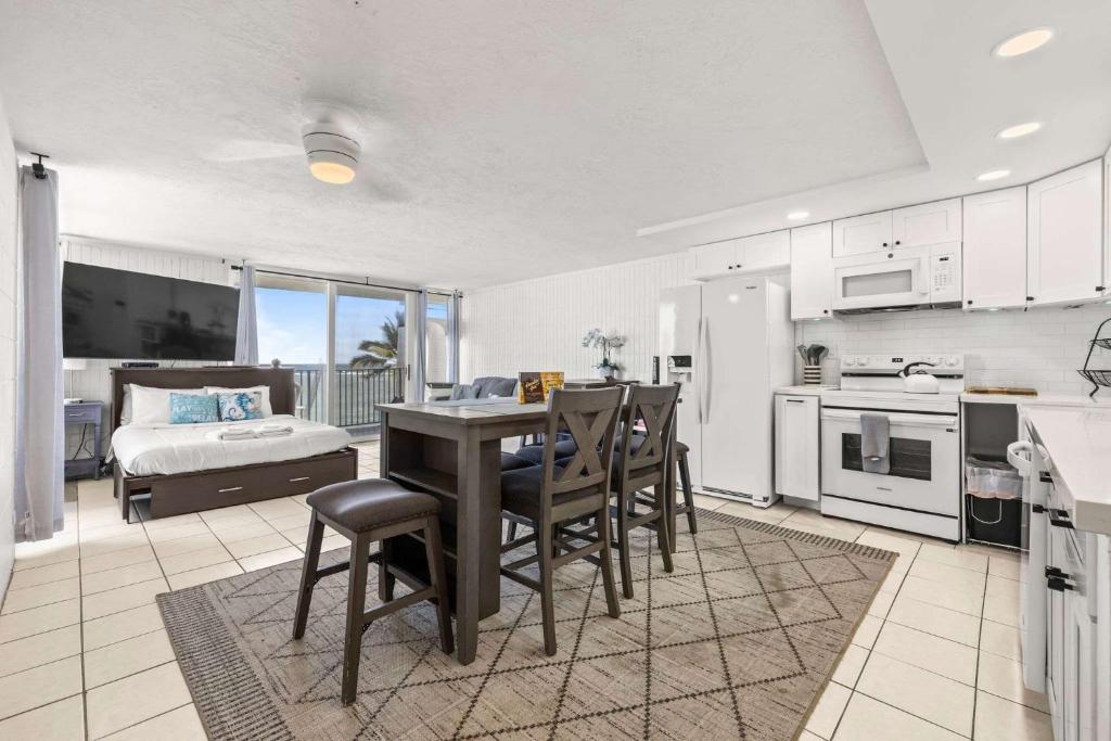 a kitchen and dining room with a table and chairs at Amazing Beachfront Condo with AC in Laie