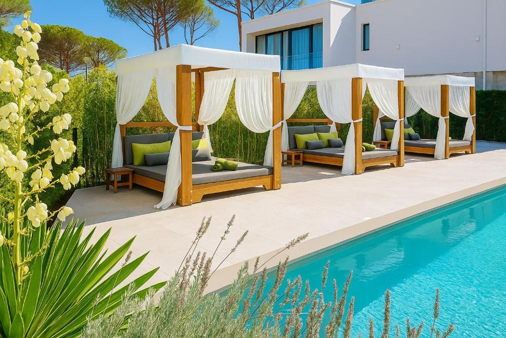 a villa with a pool and a gazebo at Rosemarine Villas in Durrës