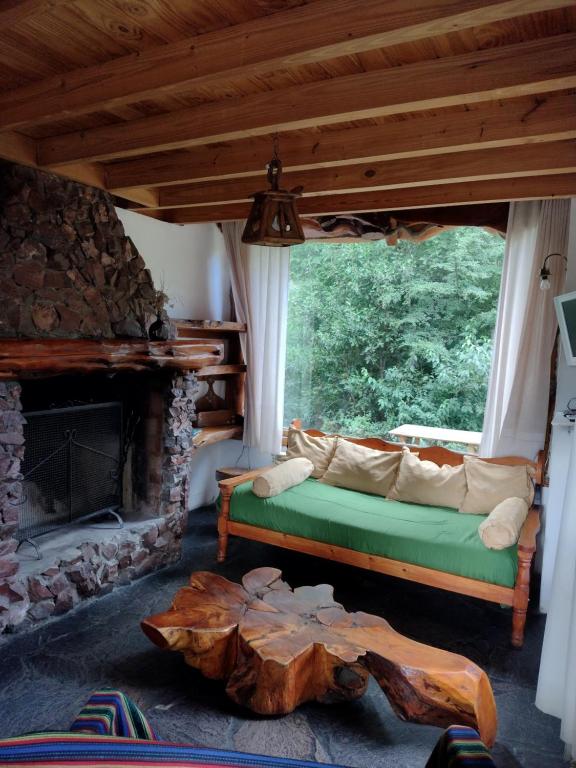 a living room with a couch and a fireplace at Cipresales in Villa La Angostura