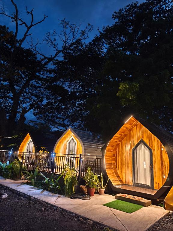 a home with a wooden house with lights on it at Rincón del Mar Glamping in Potrero
