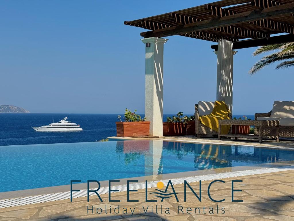 a swimming pool with a cruise ship in the background at Villa Penelope Spartia Kefalonia in Spartià