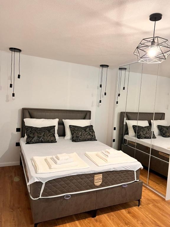 a bedroom with a bed and two mirrors at Sarajevo Soul in Sarajevo