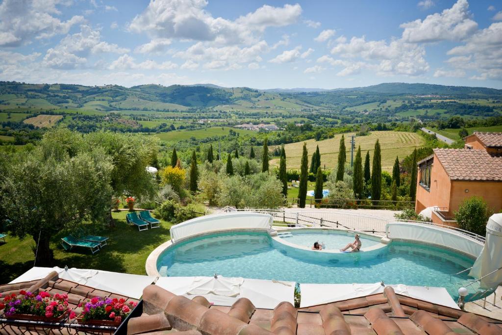 a swimming pool with a view of the hills at Hotel Saturno Fonte Pura in Saturnia