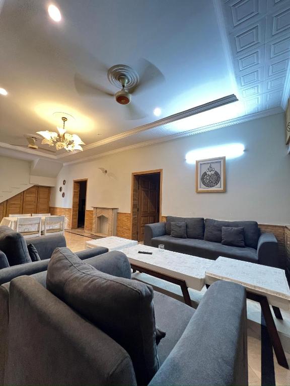 a living room with couches and a coffee table at Modern 3-Bed Retreat E11 PEACEFUL in Islamabad