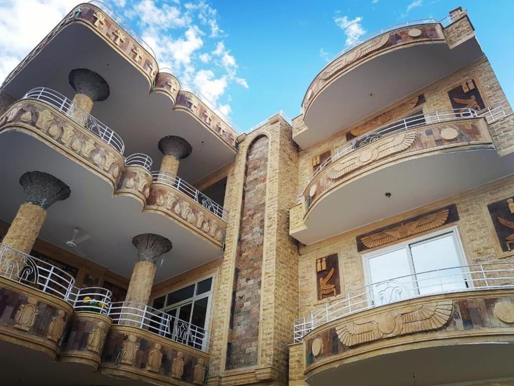 a building with balconies on the side of it at Egypt Soul hotel retreat in Luxor