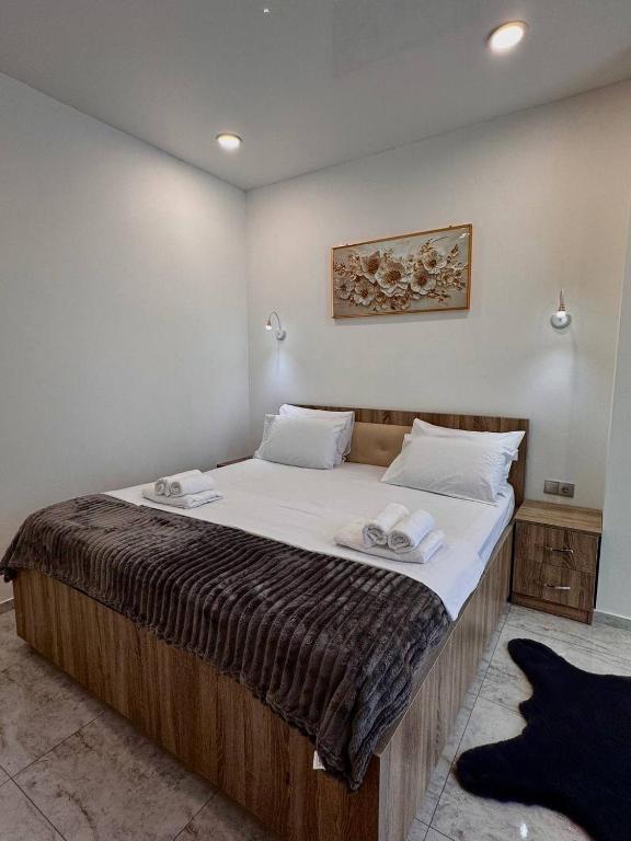 a bedroom with a large bed with two towels on it at Blue Horizon in Batumi