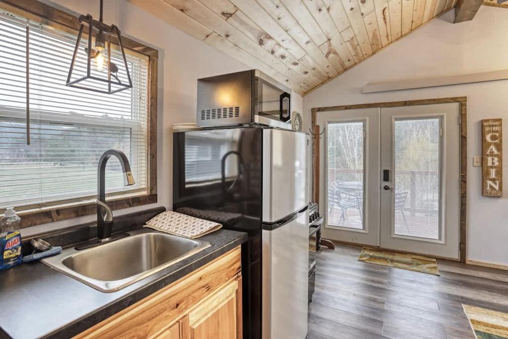 a kitchen with a stainless steel refrigerator and a sink at Cozy Creekside Retreat in Keystone
