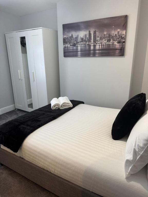 a bedroom with a bed with two pillows on it at LYMM LIVING in Warrington