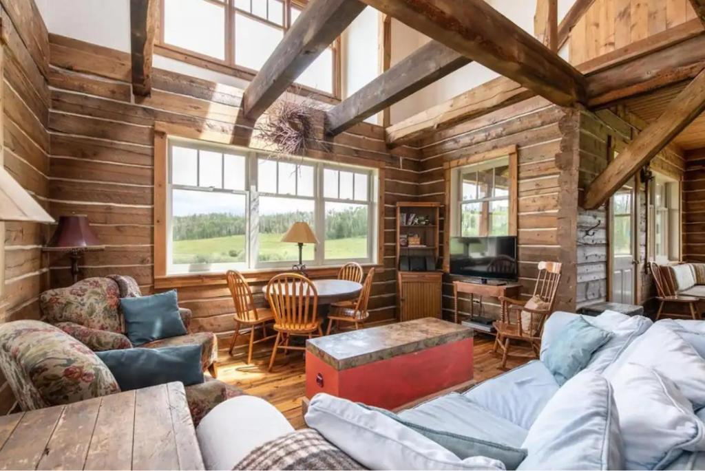 a living room with wooden walls and a wooden ceiling at Breathtaking Cabin Away From Reality in Clark