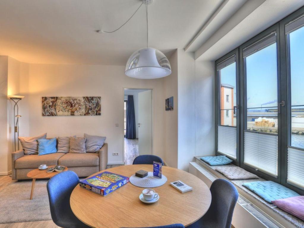 a living room with a table and chairs and a couch at Ohlerich Speicher App_ 14 in Wismar