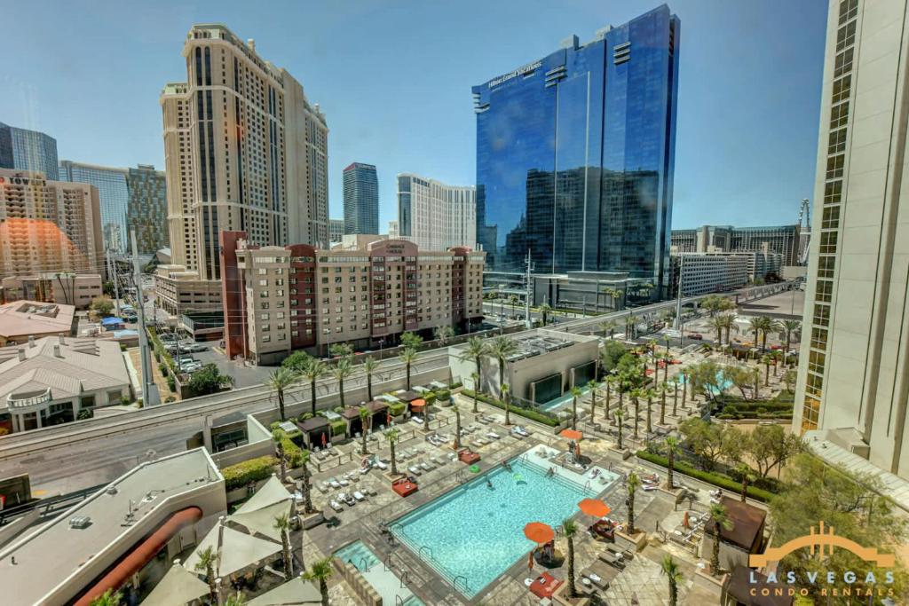 a view of a city with a pool and buildings at MGM Signature-07-703 Strip View Jacuzzi Studio in Las Vegas