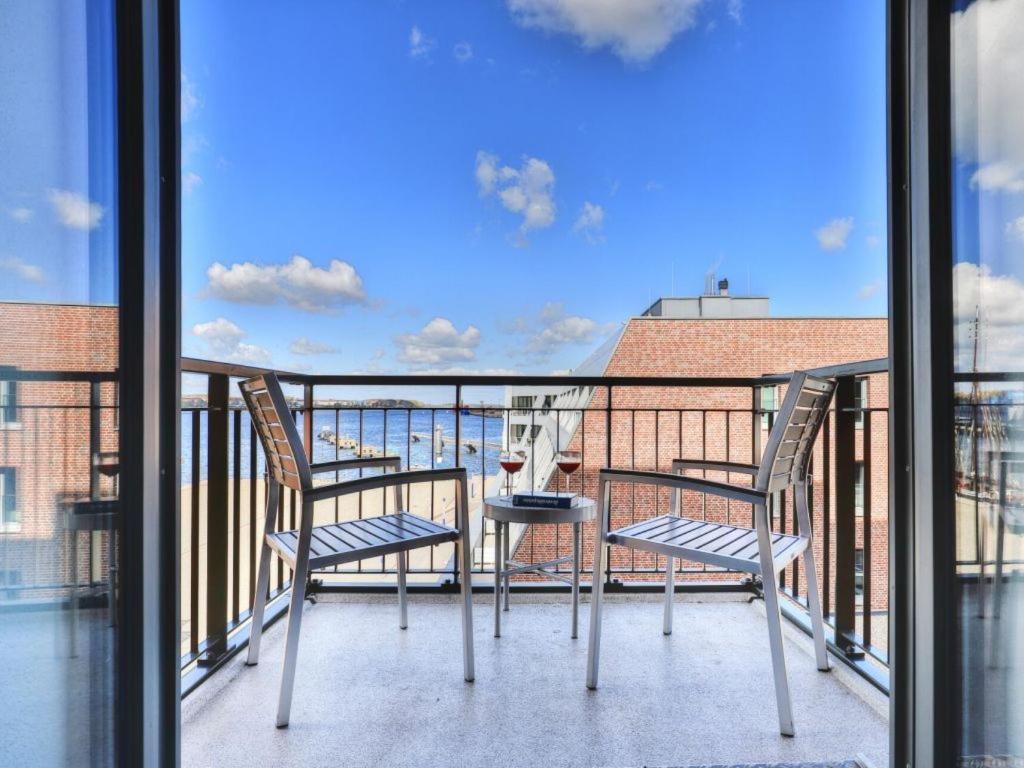 a balcony with two chairs and a table at Ohlerich Speicher App_ 19 in Wismar