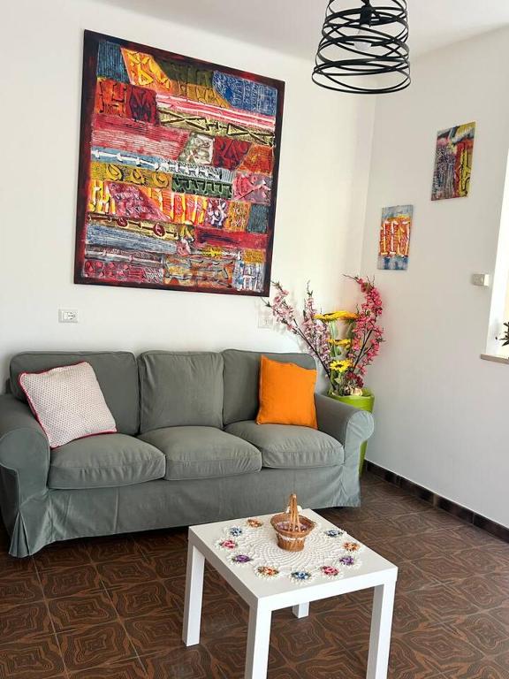 a living room with a couch and a table at Casa Giacinti in Falerone