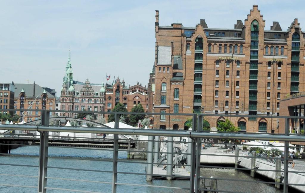 a bridge over a river in a city with buildings at Ferienhaus Robinson im Feriendorf Altes Land direkt an der Elbe in Hollern-Twielenfleth