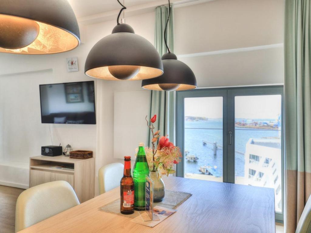 a dining room table with a view of the ocean at Ohlerich Speicher App_ 40 in Wismar
