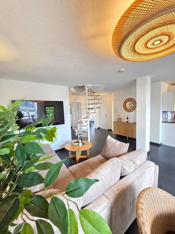 a living room with a couch and a table at Residenz Cheval - BOHO - Ravensburg - Bodensee in Ravensburg