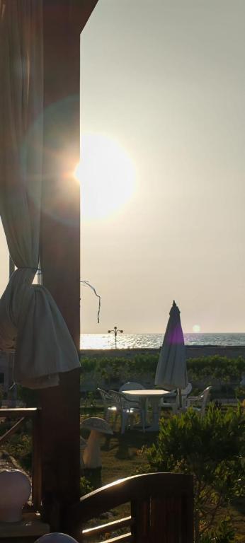 a table and an umbrella on the beach at Vacation home 32 D in Borg El Arab