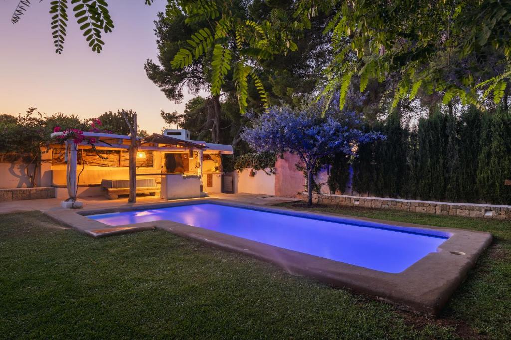 a swimming pool in the yard of a house at Latidos del mar in Denia