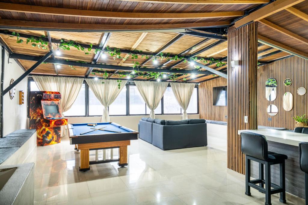 メデジンにある6 bedroom penthouse with pool table- 1 block from Lleras park p4の卓球台とソファが備わる客室です。