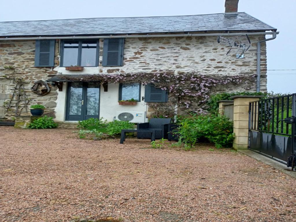 a stone house with a bench in front of it at Holiday Home in Teilhet near Chateau Rocher in Teilhet