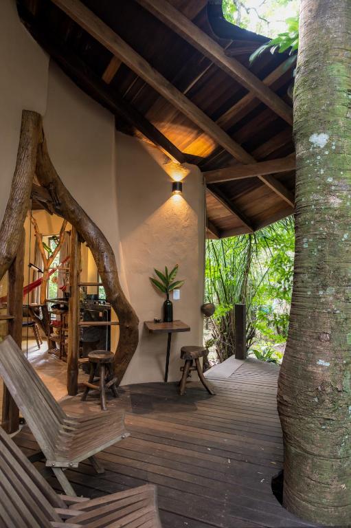 a porch of a house with a tree at Cantos da Mata in Chapada dos Guimarães