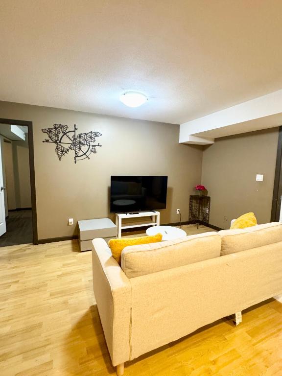 a living room with a couch and a flat screen tv at Peaceful House with Backyard in Langley