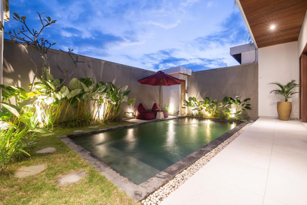 a swimming pool in the backyard of a house at 4 Bedrooms Private Pool Villa Cemagi in Cemagi
