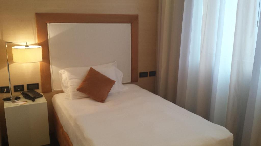 Postel nebo postele na pokoji v ubytování Hotel La Favorita