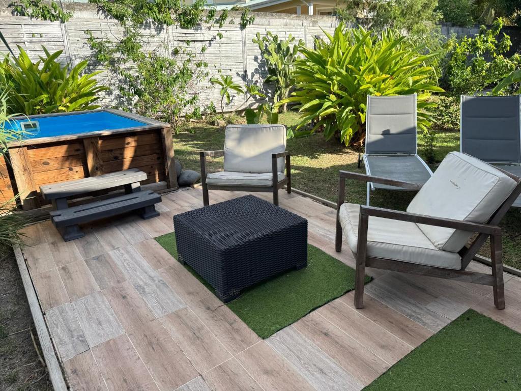 a group of chairs and a pool table on a patio at Les Ti Kaz a Papé in Deshaies