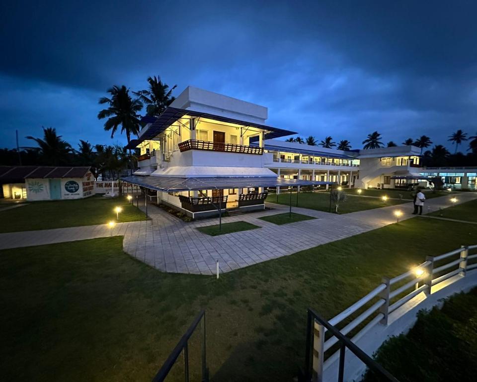 a large building at night with lights at The Marine Pride Beach Resort & Spa in Varkala
