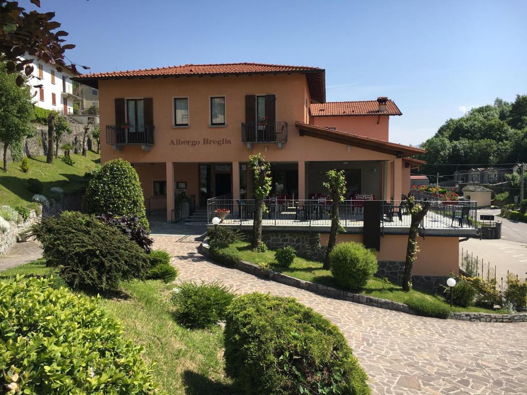 a building with a garden in front of it at Albergo Breglia in Plesio