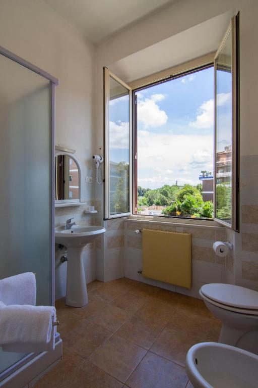 a bathroom with a sink and a large window at Ostello Villa Monte Mario in Rome