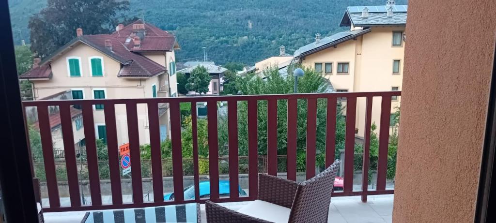 a balcony with a view of a pool and houses at Villa Rosina in Saint Vincent